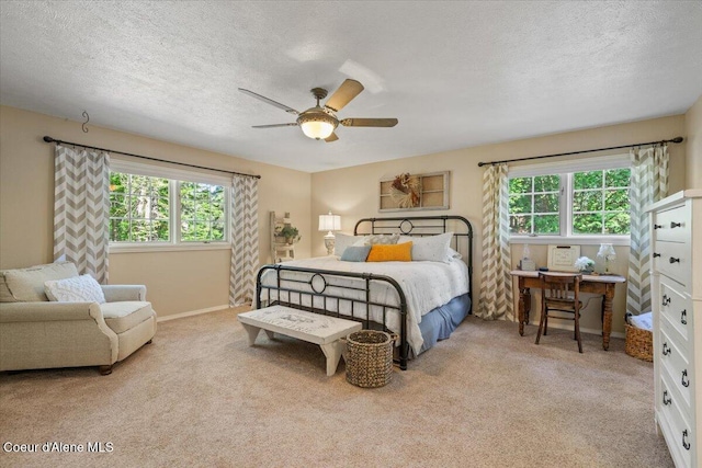 12321 N Sherwood Ct, Hayden, ID 83835 - bedroom with multiple windows, carpet flooring, a textured ceiling, and ceiling fan