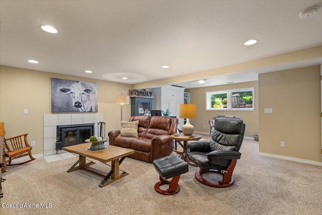 12321 N Sherwood Ct, Hayden, ID 83835 - living area with light colored carpet, recessed lighting, a tiled fireplace, and a textured ceiling