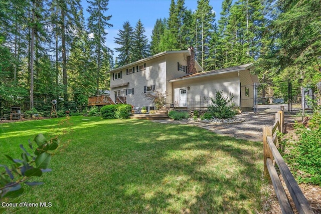 12321 N Sherwood Ct, Hayden, ID 83835 - back of house featuring a wooden deck and a chimney