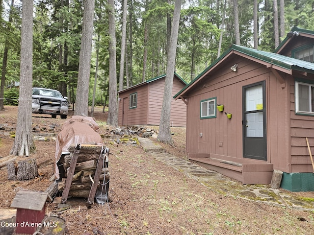 57 N Neopit Rd, Priest Lake, ID 83856 - view of property exterior featuring an outbuilding and view of scattered trees