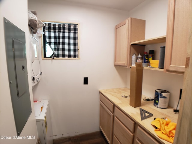 1007 Ruby Creek Rd, Naples, ID 83847 - laundry room with stacked washer / dryer, electric panel, and dark wood-style floors