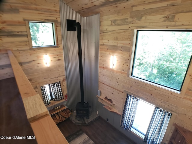 1007 Ruby Creek Rd, Naples, ID 83847 - interior space with wood walls, a wood stove, and wood finished floors