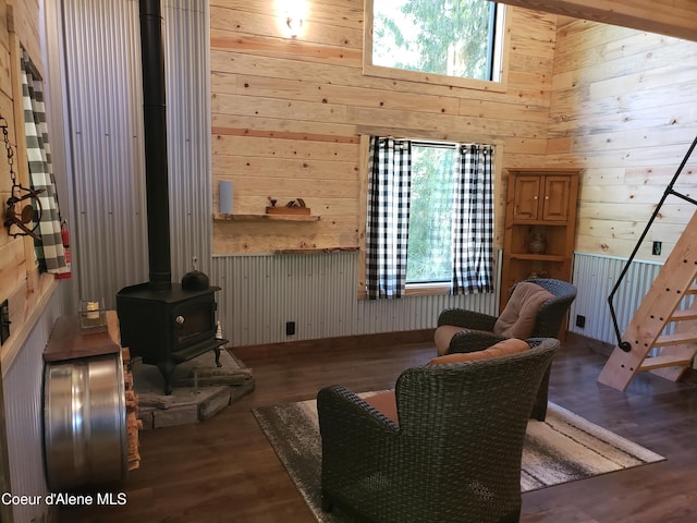 1007 Ruby Creek Rd, Naples, ID 83847 - living area featuring wooden walls, stairway, a wood stove, plenty of natural light, and wood finished floors