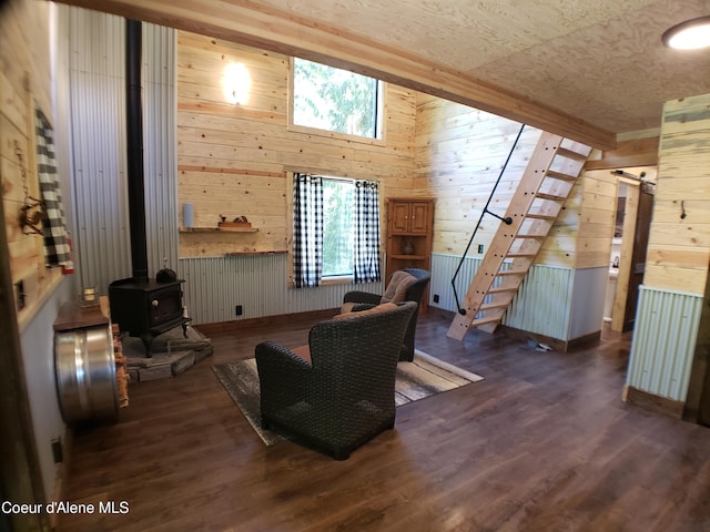 1007 Ruby Creek Rd, Naples, ID 83847 - living room featuring wood walls, a wood stove, wood finished floors, and lofted ceiling