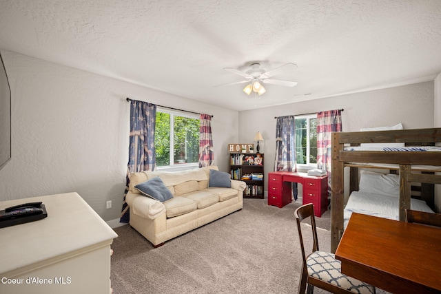 120 E Walnut Ave, Coeur Dalene, ID 83814 - bedroom featuring multiple windows, carpet flooring, ceiling fan, a textured wall, and a textured ceiling