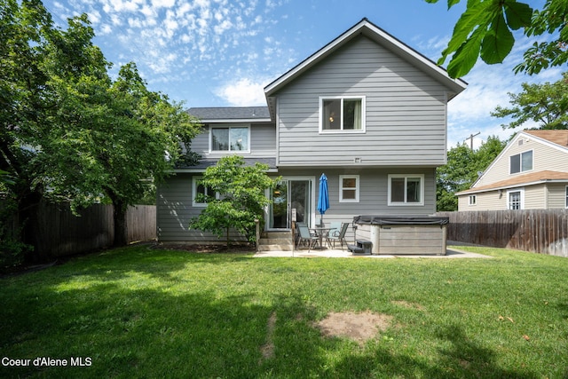 120 E Walnut Ave, Coeur Dalene, ID 83814 - back of house with a hot tub, a fenced backyard, entry steps, and a patio area
