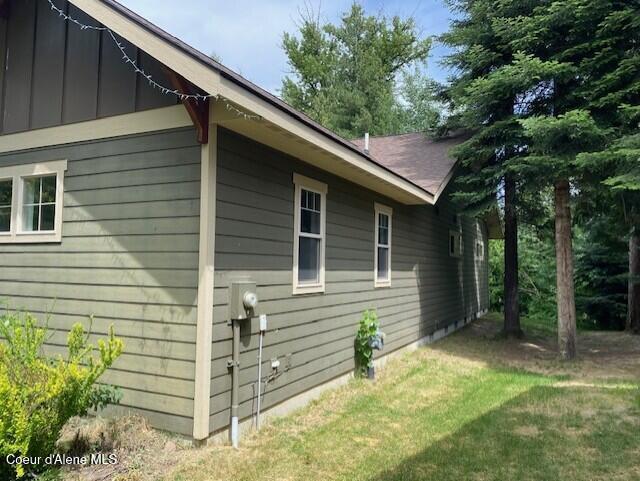 4310 Burns Ct, Sandpoint, ID 83864 - view of side of home with board and batten siding and a lawn