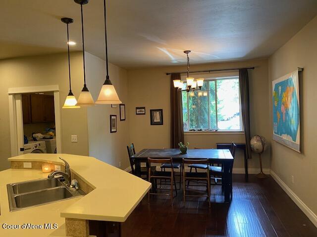 4310 Burns Ct, Sandpoint, ID 83864 - dining space with dark wood-style floors and a chandelier