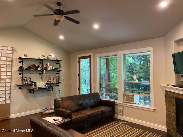 4310 Burns Ct, Sandpoint, ID 83864 - living room featuring a ceiling fan, a stone fireplace, lofted ceiling, cooling unit, and recessed lighting