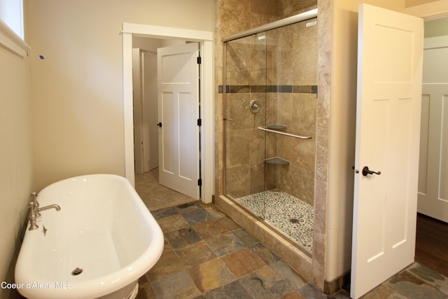 4310 Burns Ct, Sandpoint, ID 83864 - full bath with a stall shower, a soaking tub, and stone finish flooring