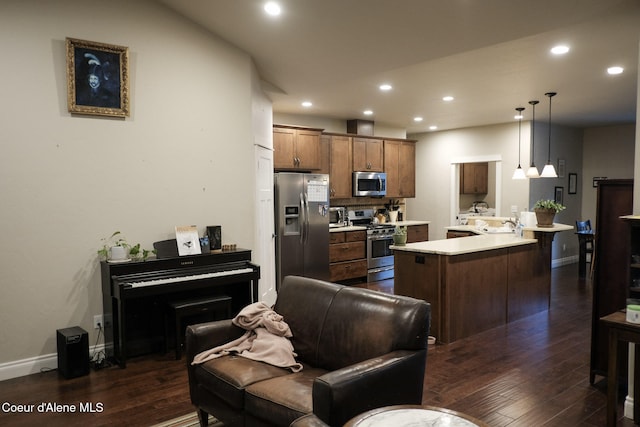 4310 Burns Ct, Sandpoint, ID 83864 - kitchen featuring stainless steel appliances, dark wood-style floors, light countertops, a peninsula, and recessed lighting