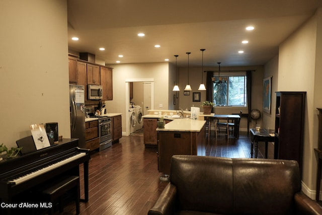 4310 Burns Ct, Sandpoint, ID 83864 - kitchen featuring stainless steel appliances, washer and dryer, recessed lighting, light countertops, and dark wood-type flooring