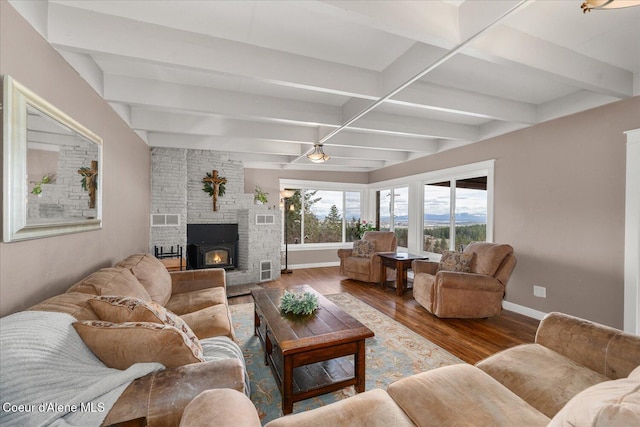 3772 S Schilling Loop, Post Falls, ID 83854 - living room featuring wood finished floors, beamed ceiling, and a large fireplace