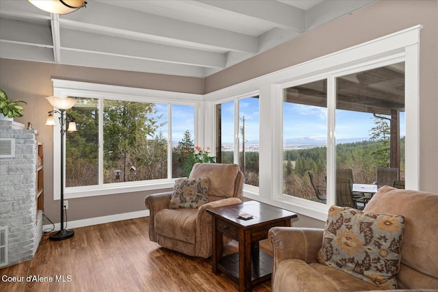 3772 S Schilling Loop, Post Falls, ID 83854 - sitting room with wood finished floors, healthy amount of natural light, a fireplace, and beamed ceiling