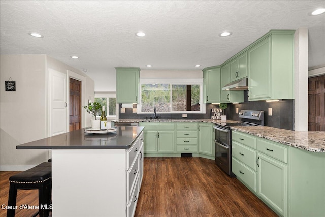 3772 S Schilling Loop, Post Falls, ID 83854 - kitchen featuring range with two ovens, under cabinet range hood, green cabinets, recessed lighting, and a textured ceiling
