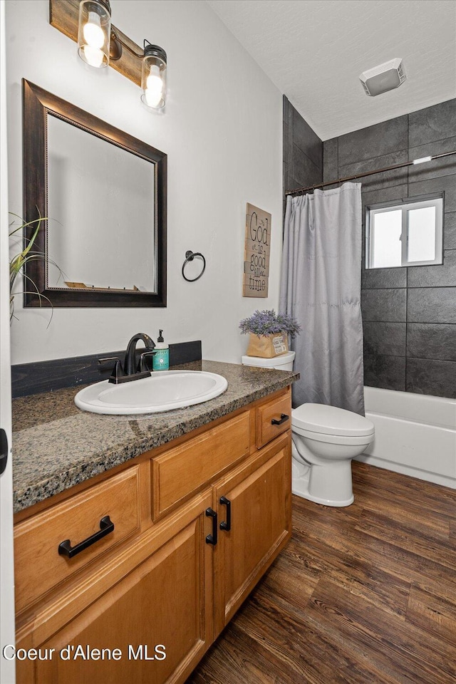 3772 S Schilling Loop, Post Falls, ID 83854 - bathroom featuring vanity, shower / bath combo, and wood finished floors