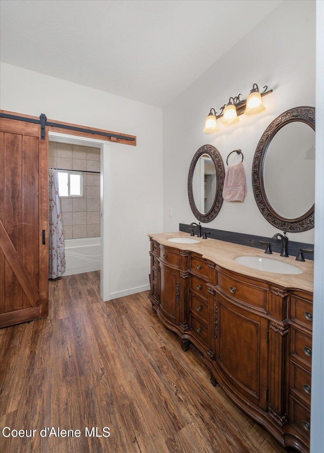 3772 S Schilling Loop, Post Falls, ID 83854 - bathroom featuring double vanity, wood finished floors, and shower / bathtub combination with curtain