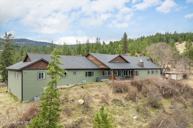 3772 S Schilling Loop, Post Falls, ID 83854 - rear view of house featuring a forest view and a mountain view