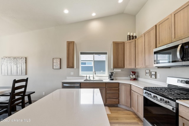 10413 N Belgrave Loop, Hayden, ID 83835 - kitchen with appliances with stainless steel finishes, vaulted ceiling, light countertops, light wood-style floors, and recessed lighting