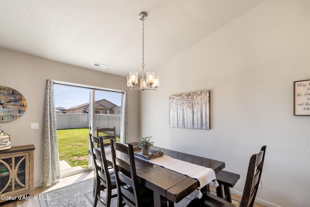 10413 N Belgrave Loop, Hayden, ID 83835 - dining space with healthy amount of natural light, a chandelier, and wood finished floors