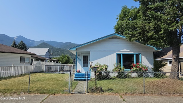 405 W Mullan Ave, Kellogg, ID 83837 - view of front of home featuring a fenced front yard, a mountain view, and a gate