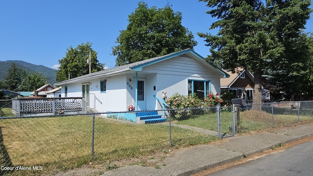 405 W Mullan Ave, Kellogg, ID 83837 - view of front facade featuring a fenced front yard and a mountain view