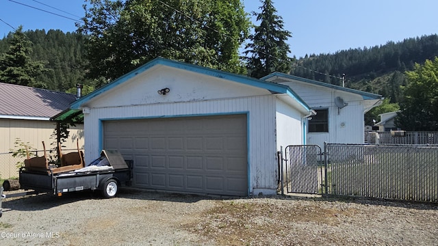 405 W Mullan Ave, Kellogg, ID 83837 - view of front of property featuring a gate, an outdoor structure, and a garage