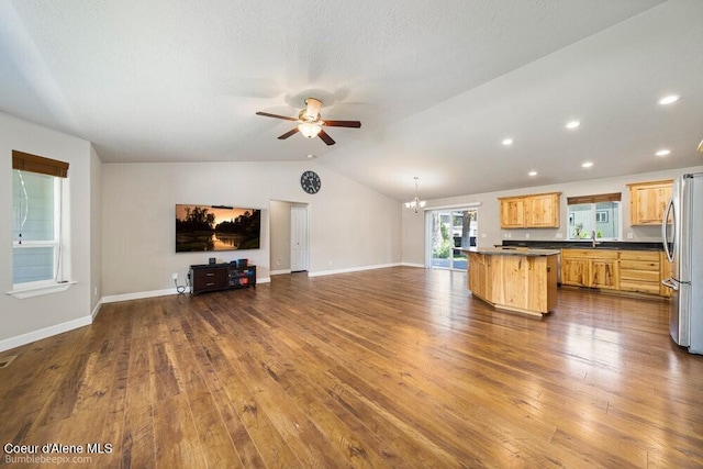3420 N 19th St, Coeur Dalene, ID 83815 - unfurnished living room featuring ceiling fan, vaulted ceiling, dark wood-type flooring, a chandelier, and recessed lighting