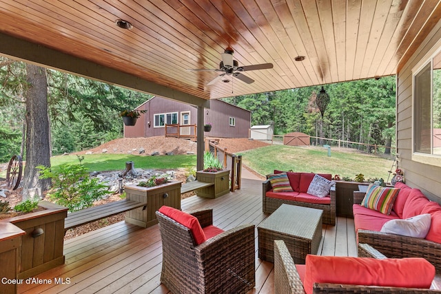 1529 S Saddleback Dr, Coeur Dalene, ID 83814 - wooden deck featuring outdoor lounge area, a yard, a ceiling fan, and an outdoor structure