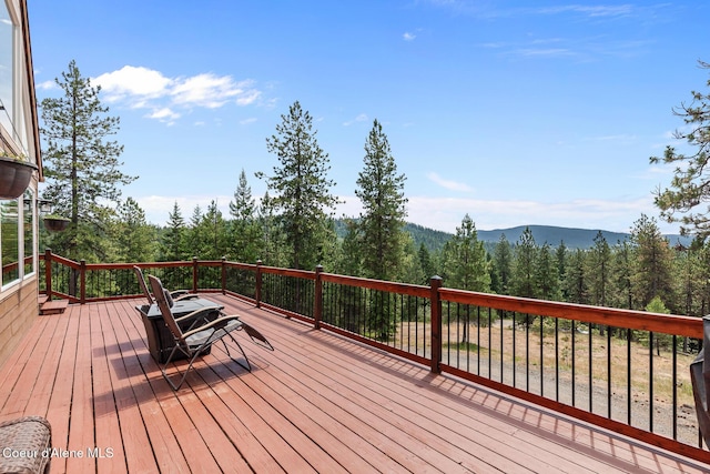 1529 S Saddleback Dr, Coeur Dalene, ID 83814 - deck featuring a wooded view and a mountain view