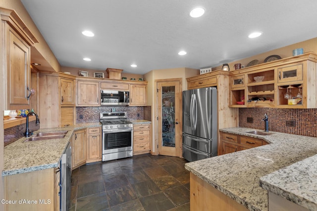 1529 S Saddleback Dr, Coeur Dalene, ID 83814 - kitchen featuring appliances with stainless steel finishes, backsplash, recessed lighting, stone tile floors, and light stone counters