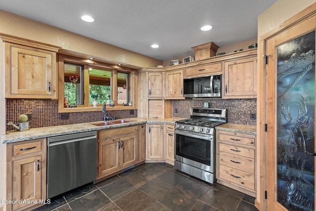 1529 S Saddleback Dr, Coeur Dalene, ID 83814 - kitchen featuring appliances with stainless steel finishes, tasteful backsplash, light stone counters, recessed lighting, and a textured ceiling