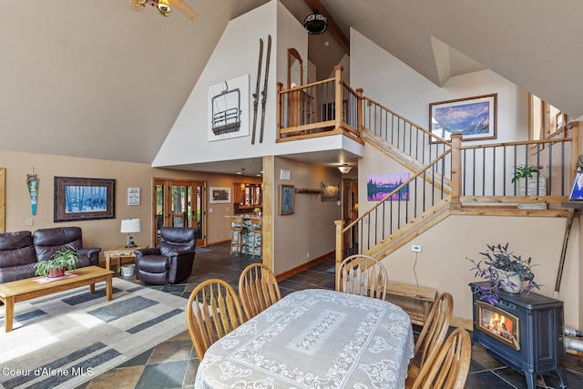 1529 S Saddleback Dr, Coeur Dalene, ID 83814 - dining room with high vaulted ceiling, a wood stove, and stairway