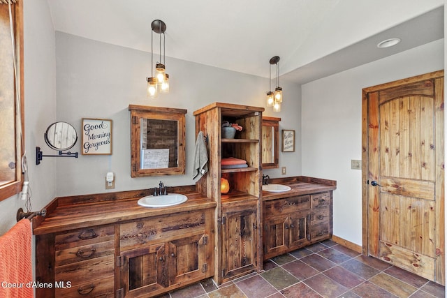 1529 S Saddleback Dr, Coeur Dalene, ID 83814 - bathroom with double vanity, vaulted ceiling, and stone finish floors