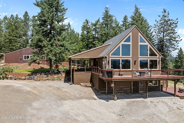 1529 S Saddleback Dr, Coeur Dalene, ID 83814 - rustic home featuring a deck and dirt driveway