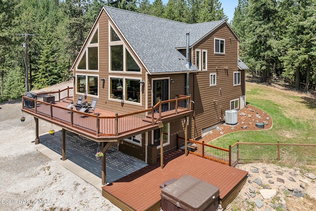 1529 S Saddleback Dr, Coeur Dalene, ID 83814 - back of house featuring a wooden deck, roof with shingles, and a yard