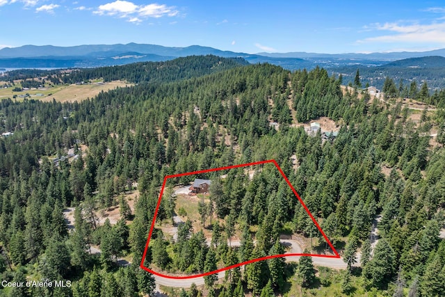 1529 S Saddleback Dr, Coeur Dalene, ID 83814 - aerial view of property and surrounding area with a mountain backdrop and property boundaries highlighted