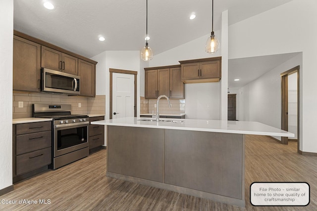 LT5BLK1 E Valley St, Oldtown, ID 83822 - kitchen with appliances with stainless steel finishes, wood finished floors, tasteful backsplash, light countertops, and recessed lighting