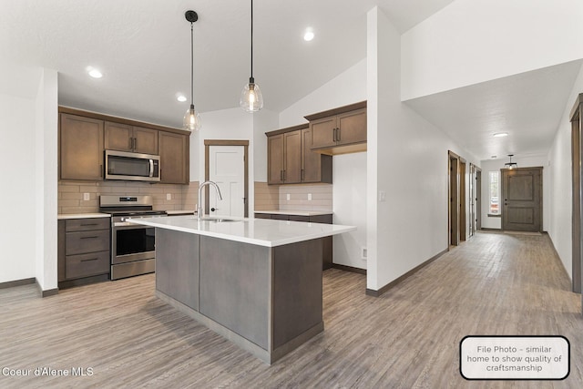 LT5BLK1 E Valley St, Oldtown, ID 83822 - kitchen featuring stainless steel appliances, decorative backsplash, light countertops, light wood finished floors, and lofted ceiling