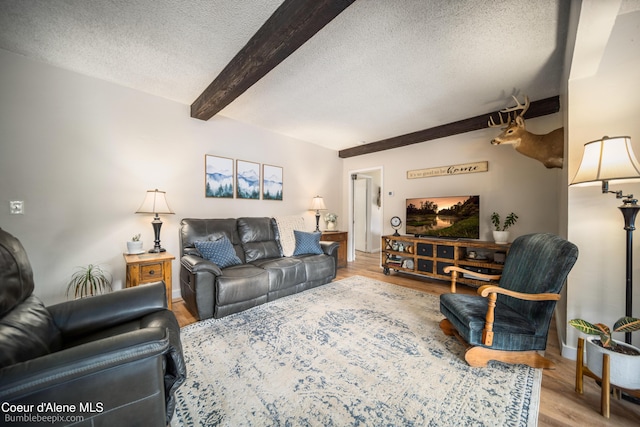 19441 N Rustic Ridge Trl, Rathdrum, ID 83858 - living room featuring beamed ceiling, a textured ceiling, and wood finished floors