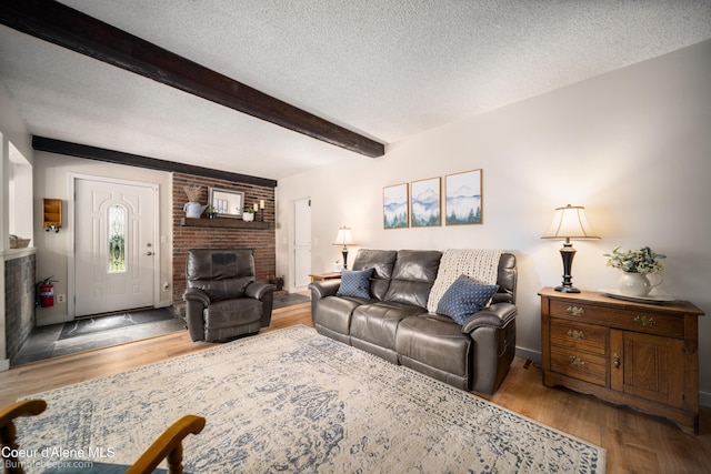 19441 N Rustic Ridge Trl, Rathdrum, ID 83858 - living area featuring a fireplace, beamed ceiling, a textured ceiling, and wood finished floors