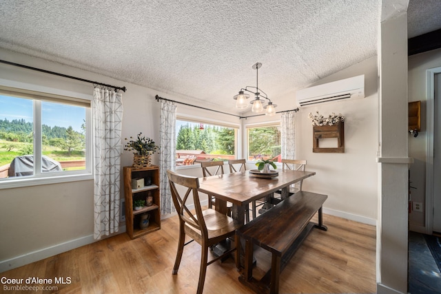 19441 N Rustic Ridge Trl, Rathdrum, ID 83858 - dining space with a wall unit AC, a textured ceiling, healthy amount of natural light, light wood-type flooring, and vaulted ceiling