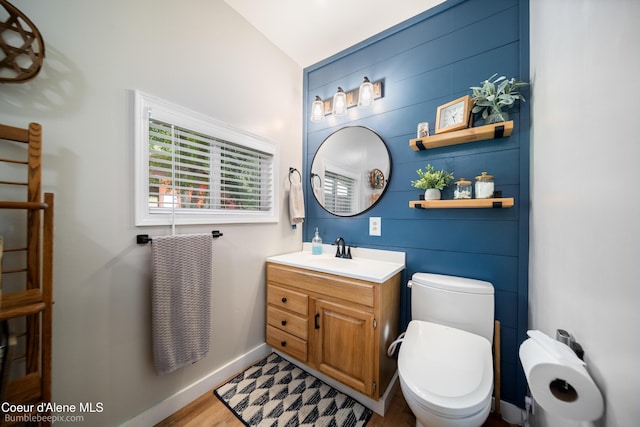 19441 N Rustic Ridge Trl, Rathdrum, ID 83858 - bathroom featuring vanity, vaulted ceiling, and wood finished floors