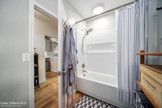 19441 N Rustic Ridge Trl, Rathdrum, ID 83858 - bathroom with shower / bath combo with shower curtain and wood finished floors