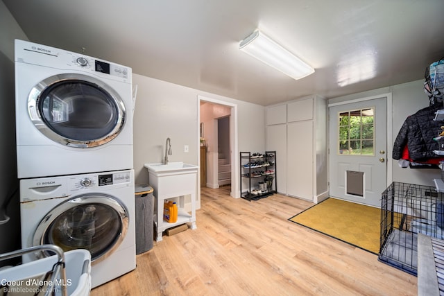 19441 N Rustic Ridge Trl, Rathdrum, ID 83858 - laundry room with stacked washer and clothes dryer and light wood-type flooring