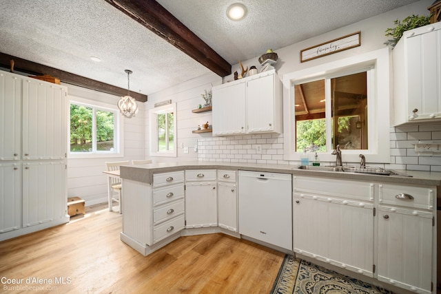 19441 N Rustic Ridge Trl, Rathdrum, ID 83858 - kitchen featuring dishwasher, light wood-style flooring, healthy amount of natural light, a textured ceiling, and a peninsula