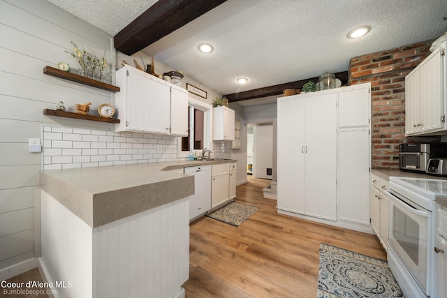 19441 N Rustic Ridge Trl, Rathdrum, ID 83858 - kitchen with white appliances, a textured ceiling, light wood-style floors, white cabinetry, and beam ceiling