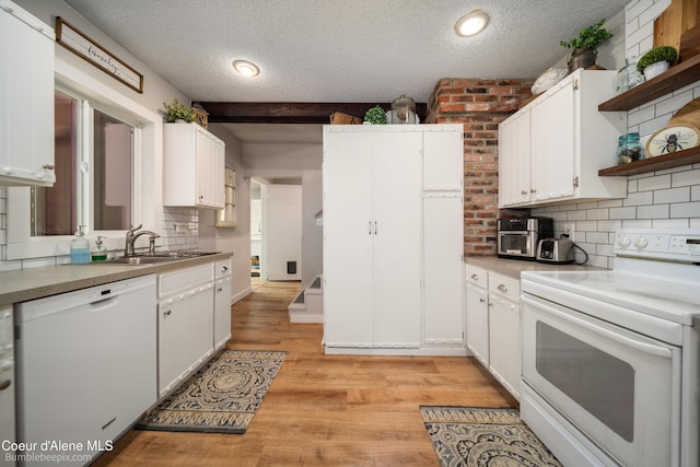 19441 N Rustic Ridge Trl, Rathdrum, ID 83858 - kitchen featuring white appliances, open shelves, a textured ceiling, light countertops, and tasteful backsplash