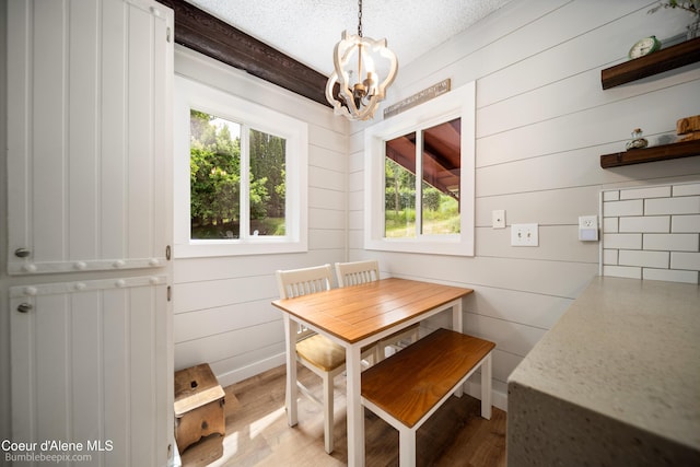 19441 N Rustic Ridge Trl, Rathdrum, ID 83858 - dining room with a chandelier, wood finished floors, and a textured ceiling