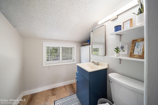 19441 N Rustic Ridge Trl, Rathdrum, ID 83858 - bathroom featuring a textured ceiling, vanity, and wood finished floors
